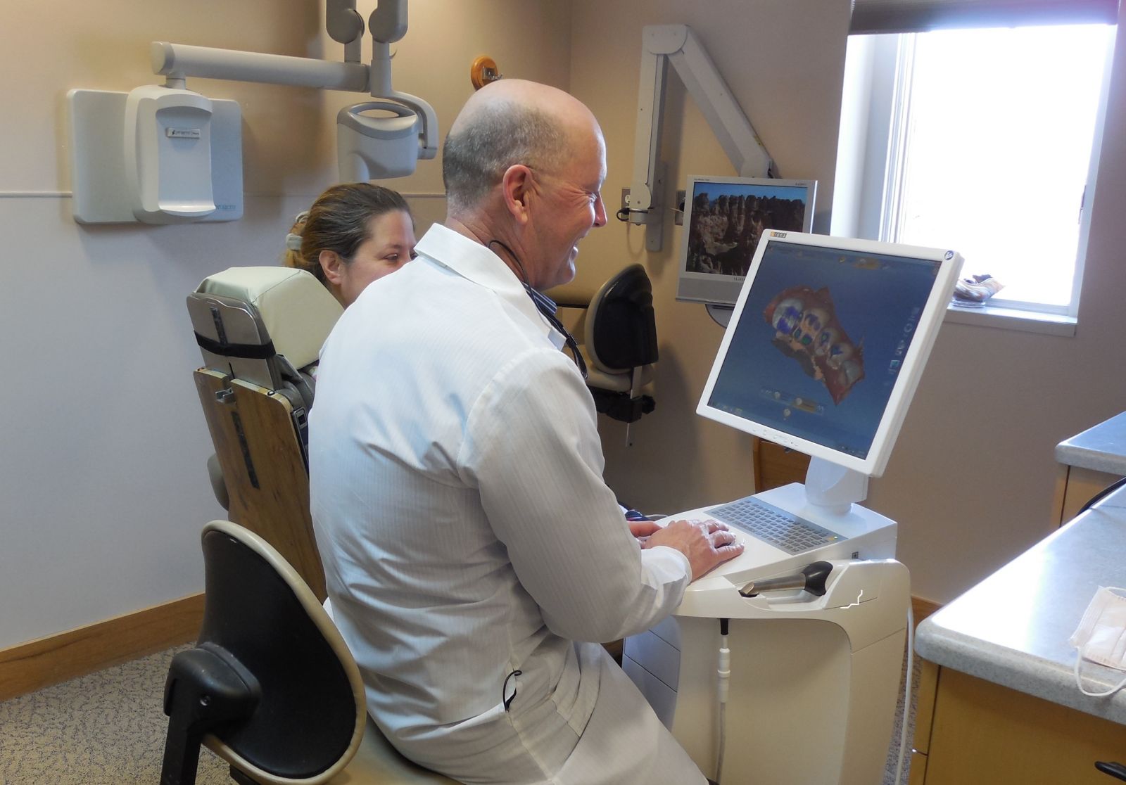 Photograph of dentist and patient during Same Day Crowns appointment, Ann Arbor, MI